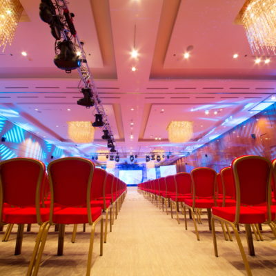 Meeting room with red chairs and colored illumination